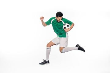 Plakat young football player in uniform jumping with soccer ball on white.