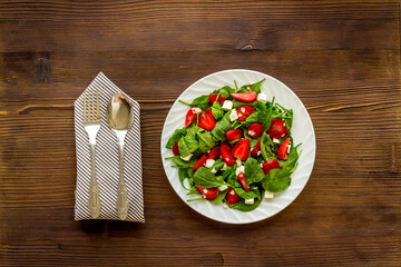 Spinach salad with strawberry and goat cheese, top view