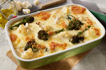 Yummy gratin with broccoli and veggies in casserole pan with cheese crust
