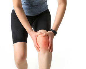 A woman in sportswear is holding a painful knee joint (marked in red)