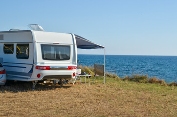 caravan trailer by the sea in summer holidays travel  tourism - obrazy, fototapety, plakaty