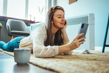 Fototapeta premium Free time. Woamn browsing on smartphone, spending time at home and relaxing, free space. Lovely message from him. Free Time At Home. Happy Woman Resting With Smartphone
