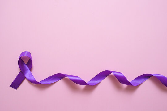 Purple ribbon as symbol of World Cancer Day concept