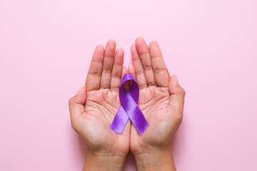 Hands holding Purple ribbons world cancer day concept