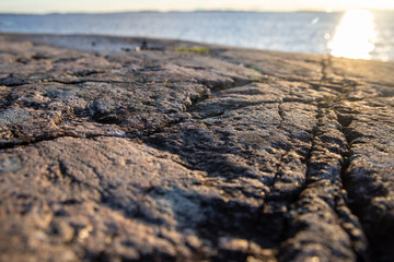 Beautiful natural Scandinavian landscape. Rocky shore at the Baltic sea with sunlight and water. Sunny late autumn or winter day in the nature in Sweden, Stockholm archipelago. Bjorno nature reserve