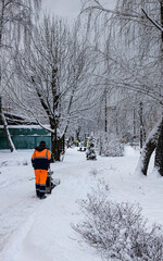  man cleans snow in the park