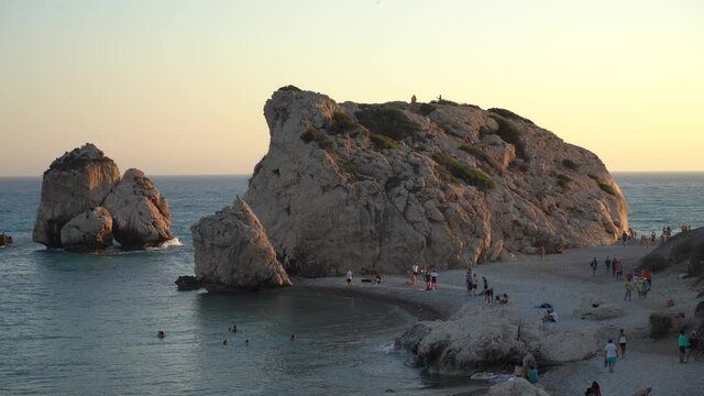 Paphos, Cyprus - August 2021: Rock of Aphrodite. Sunset on the background of the sea. Waves.
