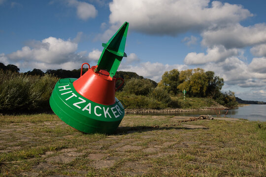 Maritime buoy near German city Hitzacker with the name of the city, river Elbe in the background