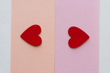 two grungy red hearts on paper