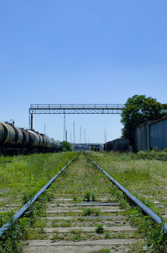 Railway to the factoryStraight railway against the background of lightning rods