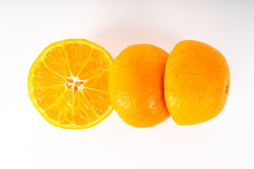 Three clementine halves on a white background