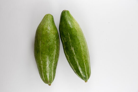 Top view of unripe healthy organic fresh unpeeled pointed gourds isolated on a white background