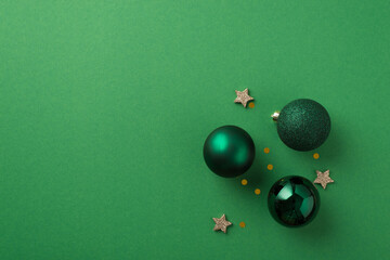 Top view photo of green christmas tree balls small glowing stars and golden sequins on isolated...