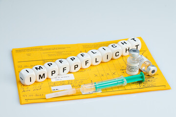 Compulsory vaccination vaccine written with dice, Covid-19