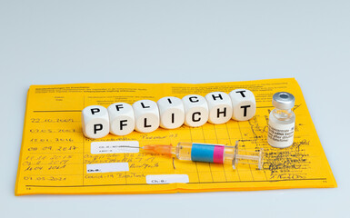 Compulsory vaccination vaccine written with dice, Covid-19