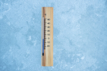 Thermometer on ice covered lake surface. -1 degrees celsius.