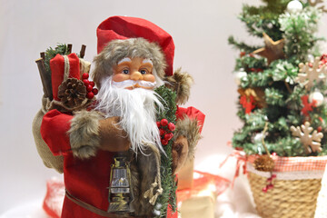 Close-up of santa claus doll, santa claus statue with christmas decorations and gifts. Winter holidays concept