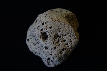 Very light piece of pumice from the Australian seaside on black background (focus on the top side), Kaiserslautern, Rhineland Palatinate, Germany
