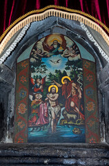 Fototapeta na wymiar Mural on a wall in the Geghard temple in Armenia.