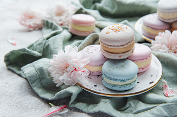 Beautiful colorful tasty macaroons on a concrete background