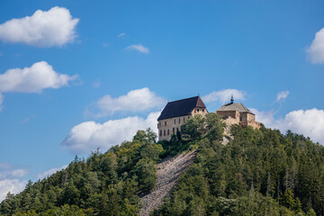 Fototapeta na wymiar Tocnik, Central Bohemia, Czech Republic, 31 July 2021: Ruins of medieval castle on hill, old stronghold with tower, ancient gothic fortress at sunny day, landmark in countryside, view from Zebrak