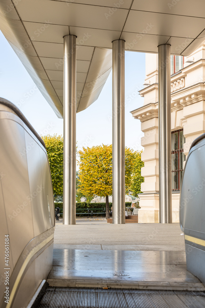 Poster vertical shot of an escalator in front of a building