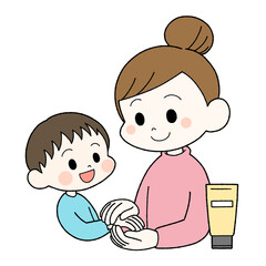 子供にハンドクリームを塗ってあげる母親