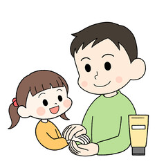 子供にハンドクリームを塗ってあげる父親