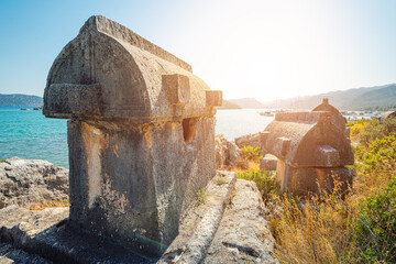 Ancient tombs of the Lycian Greek civilization on the shores of the Mediterranean Sea near the island of Kekova in Turkey. Tourist destinations in the Antalya region