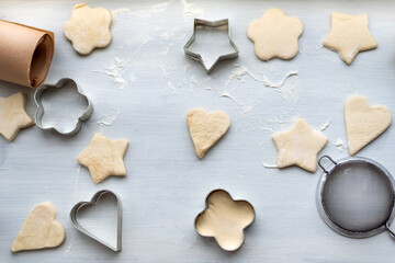 Top view of cooking a gingerbread cookie in the form of heart, star, cloud and flower. Christmas and New Year concept, festive preparations for winter hilodays