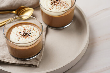 Italian chocolate and coffee mousse dessert semifreddo - half-frozen ice cream with whipped cream and cocoa powder in small glasses
