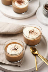 Italian chocolate and coffee mousse dessert semifreddo - half-frozen ice cream with whipped cream and cocoa powder in small glasses