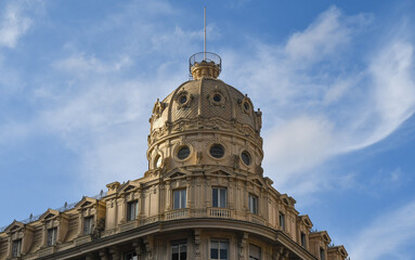 Top of the Palazzo del Credito Italiano (1914) in Piazza De Ferrari square against blue sky, Genoa, Liguria, Italy