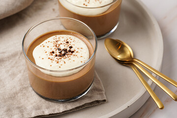 Italian chocolate and coffee mousse dessert semifreddo - half-frozen ice cream with whipped cream and cocoa powder in small glasses