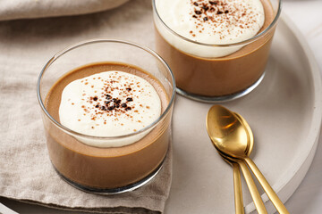Italian chocolate and coffee mousse dessert semifreddo - half-frozen ice cream with whipped cream and cocoa powder in small glasses