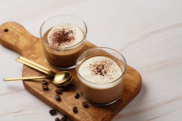 Italian chocolate and coffee mousse dessert semifreddo - half-frozen ice cream with whipped cream and cocoa powder in small glasses