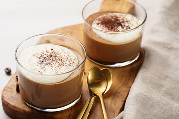 Italian chocolate and coffee mousse dessert semifreddo - half-frozen ice cream with whipped cream and cocoa powder in small glasses