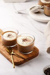 Italian chocolate and coffee mousse dessert semifreddo - half-frozen ice cream with whipped cream and cocoa powder in small glasses