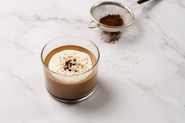 Italian chocolate and coffee mousse dessert semifreddo - half-frozen ice cream with whipped cream and cocoa powder in small glasses