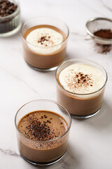 Italian chocolate and coffee mousse dessert semifreddo - half-frozen ice cream with whipped cream and cocoa powder in small glasses