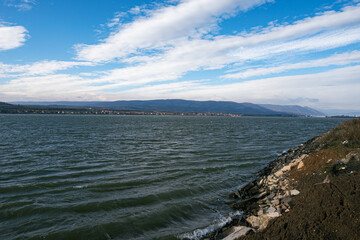 Landscape on the Danube bank. The Danube in Romania. Blue sky with clouds.