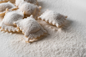Obraz na płótnie Canvas Ravioli pasta squares sprinkled with flour.