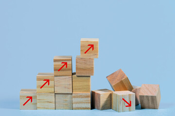Collapsed stair structure of wooden cubes with upward pointing arrows, business risk due to inflation, global crisis or unsustainable financial concept, light blue background with copy space - 476066422