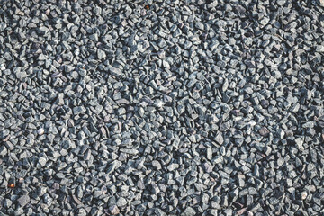 Garden gravel background stone landscaping. Driveway gravel road. Crushed stone road building material gravel texture. Crushed rock close up. Small rocks ground. Small stone construction material rock