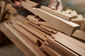 Close up of male hand holding wooden plank