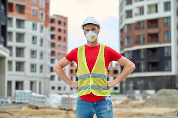 Man standing at construction site looking at camera