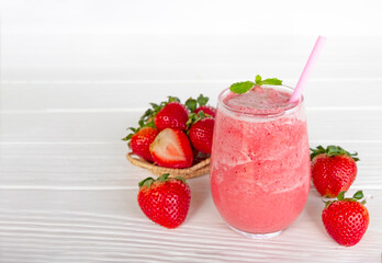 Strawberry yogurt fruit juice smoothie pink colorful fruit juice milkshake blend beverage healthy high protein the taste yummy In glass drink episode morning on white wood background.
