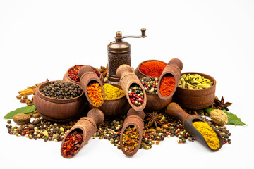 Assortment of oriental spices in wooden utensils isolated on a white background.