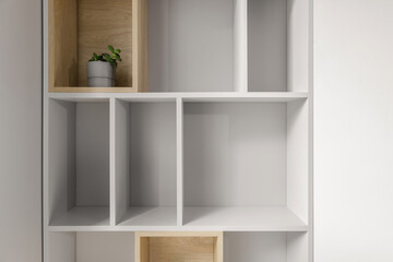 Light grey bookshelf in minimalistic design interior