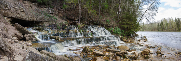 Fototapeta premium the waterfall emanating from under ground on the river Poneretka